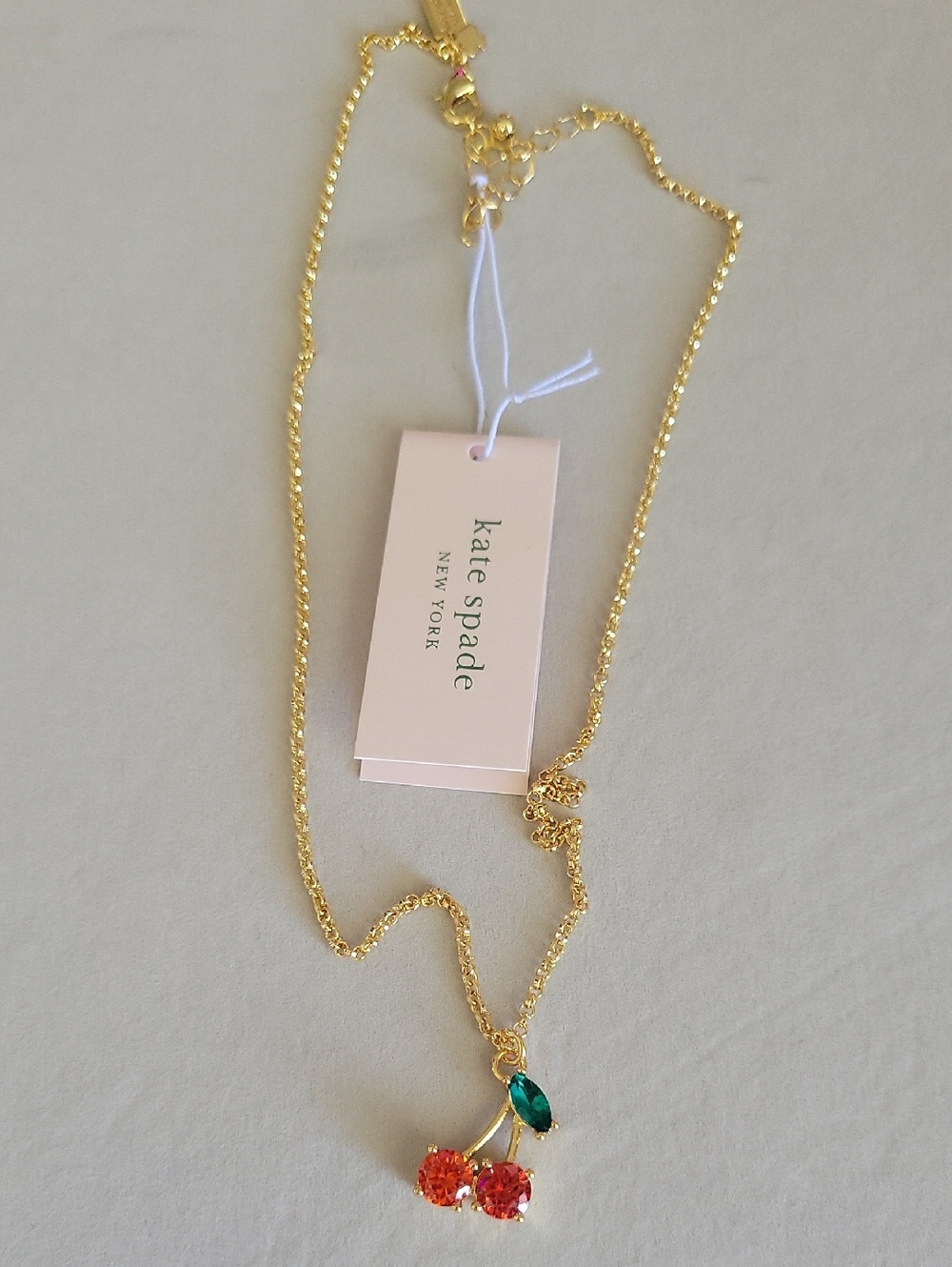 kate spade Gold Cherry Pendant Necklace with Orange and Green Stones